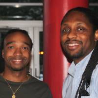 2 men attendees pose